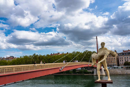 Lyon, France - Sep 28, 2020: Marble statue of 2 men called The Weight of Oneself by Scandinavian duo Elmgreen and Dragset overlooking the Saone river in front of Lyons Palace of Justice.のeditorial素材