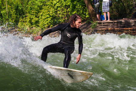 Munich, Germany - July 13, 2019: Surfer in the city river, Munich is famous for people surfing in...