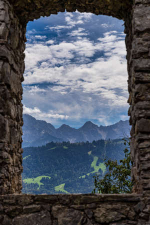 Mountain view through a window of the karwendel mountains with clouds in bavaria, germany. Seen from the Kramer Plateauwegの写真素材