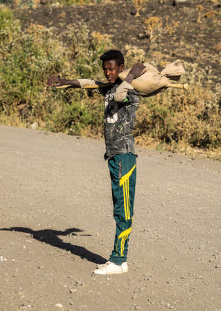 Lalibela, Ethiopia - Feb 12, 2020: Ethiopian boy seen on the road from Lalibela to Gheralta, Tigray in Northern Ethiopia, Africaのeditorial素材
