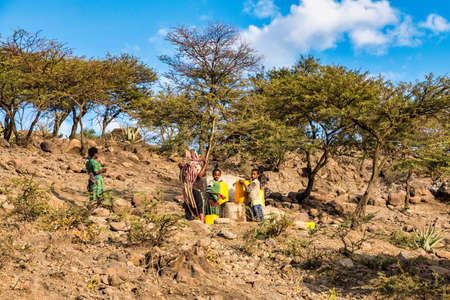 Lalibela, Ethiopia - Feb 12, 2020: People getting water at a water point in lalibela, ethiopia....