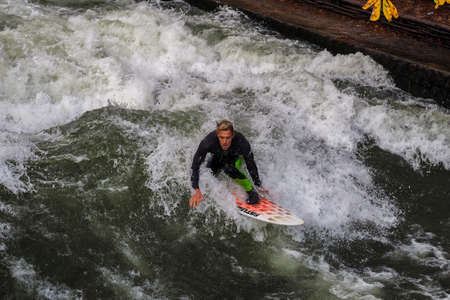 Munich, Germany - October 13, 2018: Surfer in the city river, Munich is famous for people surfing in...
