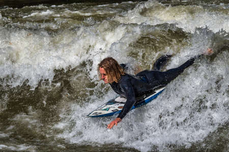 Munich, Germany - October 13, 2018: Surfer in the city river, Munich is famous for people surfing in...