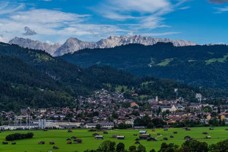 Mountain view through a window of the karwendel mountains with clouds in bavaria, germany. Seen from the Kramer Plateauwegの写真素材