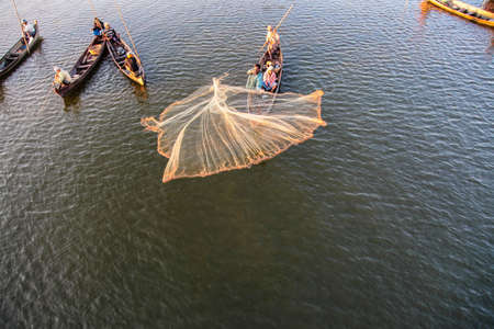 Mandalay, Myanmar - Nov 12, 2019: Fishermen near U Bein bridge in Amarapura,Mandalay Myanmar