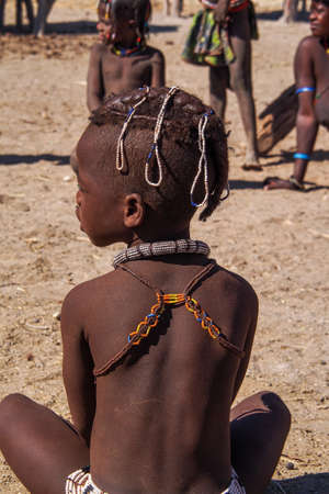 Opuwo, Namibia - Jul 07, 2019: Young unidentified Himba infant in a himba tribe villageのeditorial素材