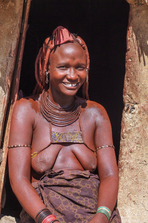 Opuwo, Namibia - Jul 07, 2019: Unidentified Himba woman with the typical necklace and hairstyle in...