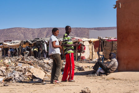 Opuwo, Namibia - Jul 07, 2019: Namibian teenagers on the street, seen in Opuwo, the capital of the Kunene Region in north-western Namibia, Africaのeditorial素材