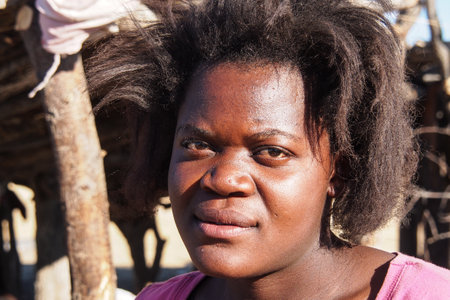 Opuwo, Namibia - Jul 07, 2019: Unidentified Himba woman with the typical necklace and hairstyle in himba tribe villageのeditorial素材