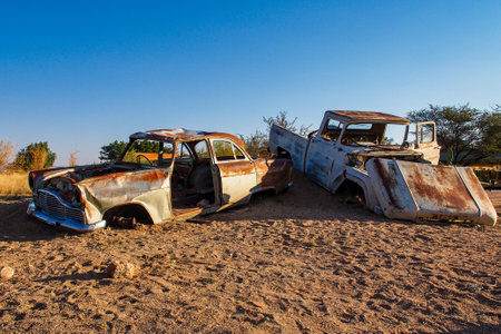 Solitaire, Namibia - Jul 12, 2019: Wrecked cars lie abandoned in the desert surrounding Solitaire in Namibia.のeditorial素材