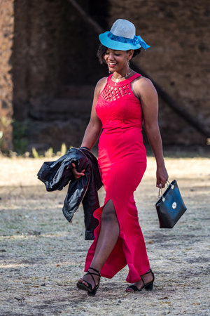 Gondar, Ethiopia - Feb 06, 2020: Young girl poses for a portrait taken at Fasil Ghebbi, the remains...