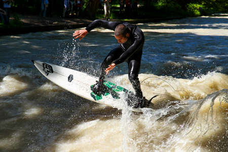 Munich, Germany - July 13, 2019: Surfer in the city river, Munich is famous for people surfing in...