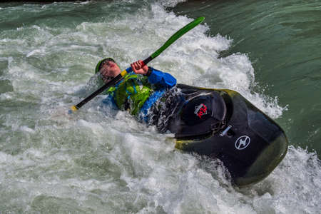 Augsburg, Germany - June 16, 2019: Whitewater kayaking, extreme kayaking. A guy in a kayak sails on...