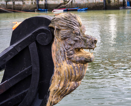 Decorative figure of a lion on the prow of an ancient sailboat at Bermeo in the Basque Country in Spainの写真素材