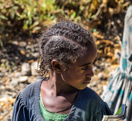 Lalibela, Ethiopia - Feb 12, 2020: Ethiopian girl seen on the road from Lalibela to Gheralta, Tigray in Northern Ethiopia, Africaのeditorial素材