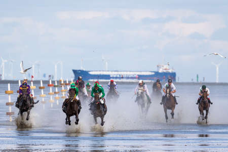 Cuxhaven, Germany - Aug 25, 2019: equestrian at the horse race in the mud flat at Duhner Wattrennen in Germanyのeditorial素材