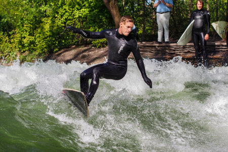 Munich, Germany - July 13, 2019: Surfer in the city river, Munich is famous for people surfing in urban enviroment called Eisbachのeditorial素材