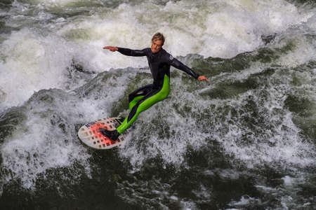 Munich, Germany - October 13, 2018: Surfer in the city river, Munich is famous for people surfing in...