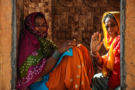 Jodhpur, India - Jan 02, 2020: Traditionally dressed unidentified old indian women sit in front of her house in Jodhpur, Indiaのeditorial素材