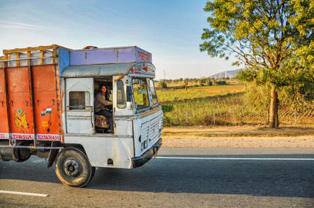 Jaipur, India - Jan 04, 2020: Happy Asian Indian lorry driver sitting in his truck and smiling happily at Jaipur, Indiaのeditorial素材