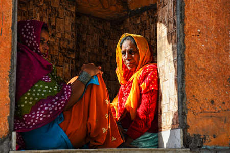 Jodhpur, India - Jan 02, 2020: Traditionally dressed unidentified old indian women sit in front of...