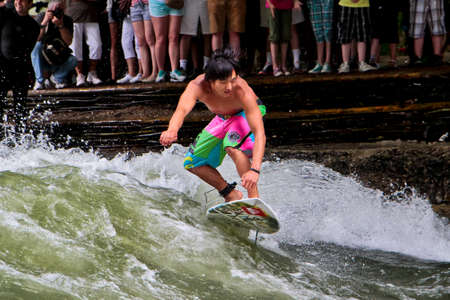 Munich, Germany - July 05, 2021: Surfer in the city river, Munich is famous for people surfing in urban enviroment called Eisbachのeditorial素材