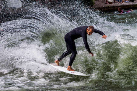 Munich, Germany - July 05, 2021: Surfer in the city river, Munich is famous for people surfing in urban enviroment called Eisbachのeditorial素材