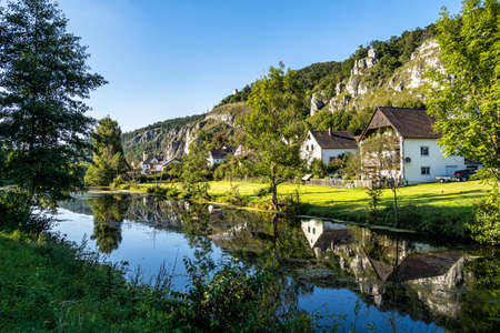Idyllic sunset view with reflections of Markt Essing with the ruin of Randeck castle over the river Altmuehl in Bavaria, Germanyの写真素材