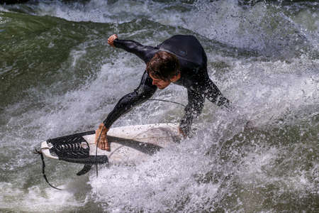 Munich, Germany - July 13, 2021: Surfer in the city river, Munich is famous for people surfing in urban enviroment called Eisbachのeditorial素材