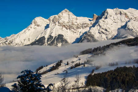 Beautiful idyllic winter landscape, stunning mountain range, snowy trees and blue sky at Maria Alm, Hinterthal in Austriaの写真素材