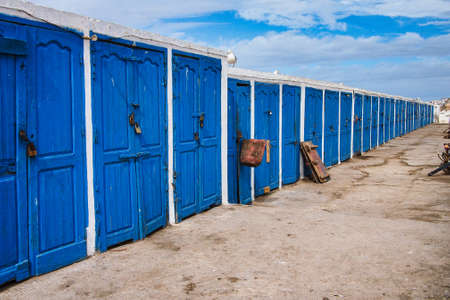 Blue wooden doors of the huts in the fishing port of Essaouira, Morocco in Africaの写真素材