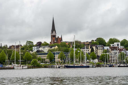 Flensburg, Germany - May 27, 2021: Sail boats in the port of Flensburg, St. Jorgen's Church in the background. Schleswig-Holstein in Germany, Europeのeditorial素材