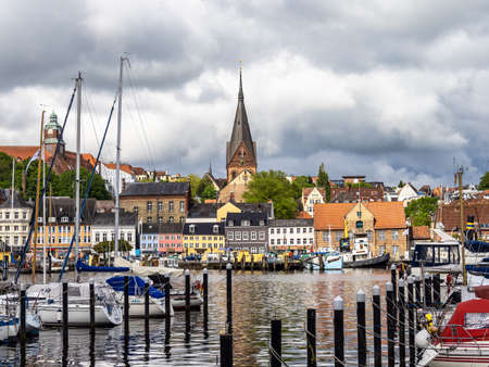 Flensburg, Germany - May 27, 2021: Sail boats in the port of Flensburg, St. Jorgen's Church in the background. Schleswig-Holstein in Germany, Europeのeditorial素材