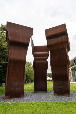 Munich, Germany - Jul 07, 2021: Big rusty monument sculpture in green park between Alte Pinakotek...