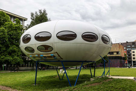 Munich, Germany - Jul 07, 2021: The Futuro House of the shape of a flying saucer designed in 1968 by Finnish architect Matti Suuronen in front of the Pinakothek der Moderne, Gallery of the Modernのeditorial素材