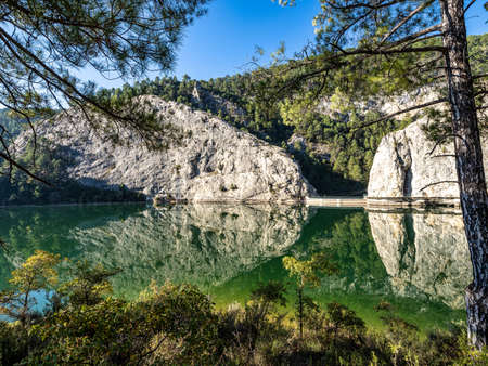 Embalse del Molino De Chincha reservoir with turquoise waters in autumn at Cuenca province in...