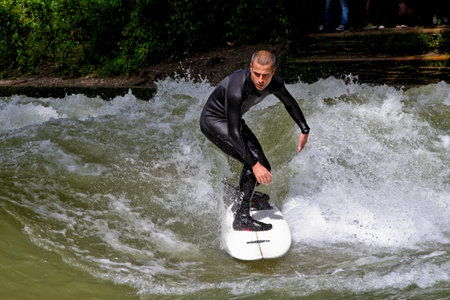 Munich, Germany - Jun 04, 2022: Surfer in the city river, Munich is famous for people surfing in urban environment called Eisbachのeditorial素材