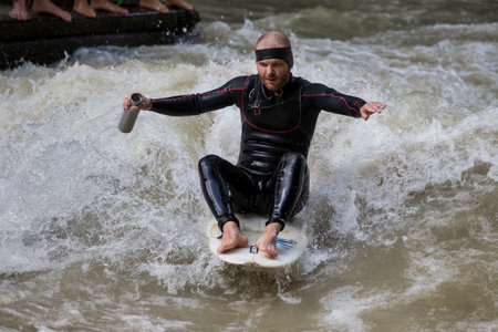 Munich, Germany - Jun 04, 2022: Surfer in the city river, Munich is famous for people surfing in...