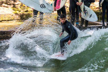 Munich, Germany - Jun 04, 2022: Surfer in the city river, Munich is famous for people surfing in...