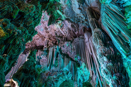 Gibraltar, United Kingdom - Nov 18, 2022: Upper Rock Nature Reserve at Gibraltar. Exploring Old St. Michaels Cave, that has been illuminated with colorful LED lighting, located at the Upper Rock Nature Reserve at Gibraltar.のeditorial素材