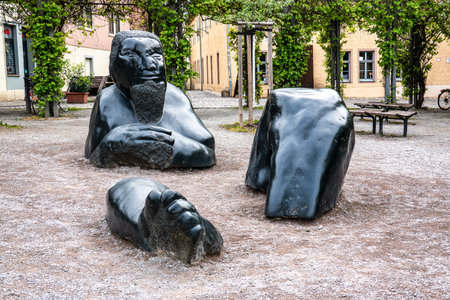 Weimar, Germany - May 10, 2023: Sunken Giant is a plastic sculpture of a reclining giant made of volcanic rock picrite, on Frauenplan park near the Goethehaus in Weimar, Germanyのeditorial素材