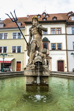 Weimar, Germany - May 10, 2023: Neptune fountain from 1774 by Martin Gottlieb Klauer with gold crown and trident on marketplace square in Weimar, Germanyのeditorial素材