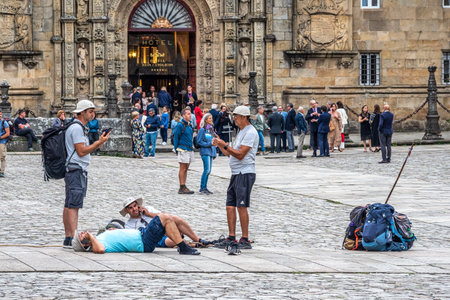 Santiago de Compostela, Spain - Jun 18, 2023: Pilgrims and tourists in front of the Cathedral at Santiago de Compostela, Galicia, Spain.のeditorial素材
