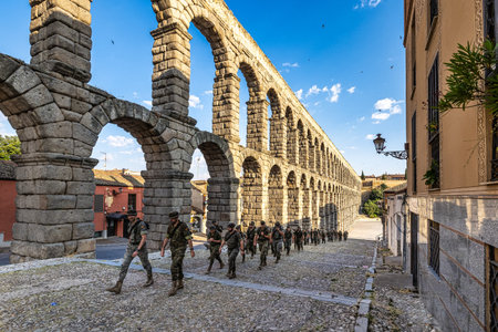 Segovia, Spain - Jul 06, 2023: Soldiers at the Roman Aqueduct of Segovia, one of the best-preserved elevated Roman Aqueducts and a symbol of Segovia. Castile and Leon, Spain.のeditorial素材
