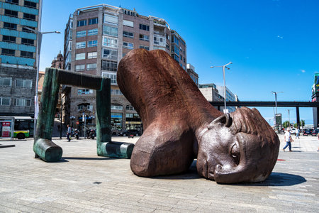 Vigo, Spain - Jun 29, 2023: Port of Vigo in Galicia, Spain, Europe with head of El Banista del Arenal sculpture by Leiroのeditorial素材