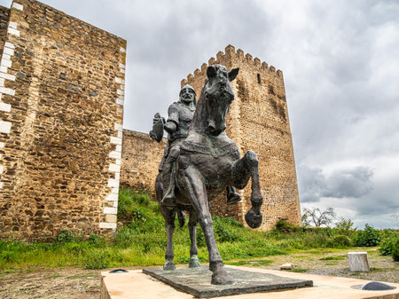 An equestrian statue of Ibn Qasi, the proclaimed political and spiritual leader of the Taifa kingdom of Mertola, with the keep tower of Mertola Castle on the background. Mertola. Portugalの写真素材