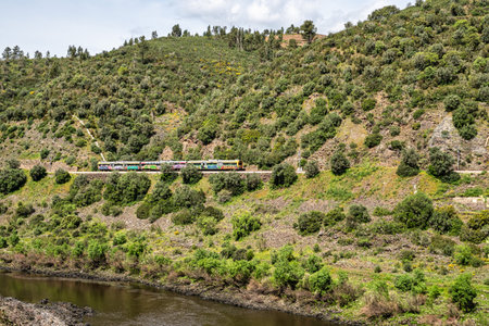 A train going alongside the walkways in Amieira do Tejo in Portugal.の写真素材