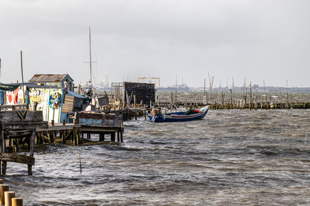 Traditional fishermen wooden jetties at Carrasqueira, Portugal. Stilt piers or Cais Palafitico by...