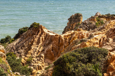 Praia da Marinha Beach among rock islets and cliffs seen from Seven Hanging Valleys Trail, Percurso dos Sete Vales Suspensos. Portugalの写真素材