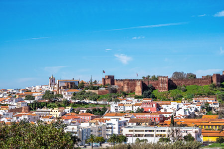 View of Silves town buildings with famous castle and cathedral, Algarve region, Portugal. Walls of medieval castle in Silves town, Algarve region, Portugal.の写真素材